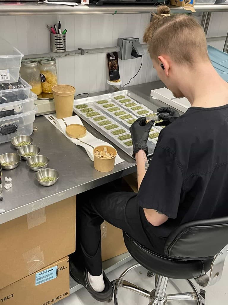 Shaggy Rolls hand-rolling at the prep table